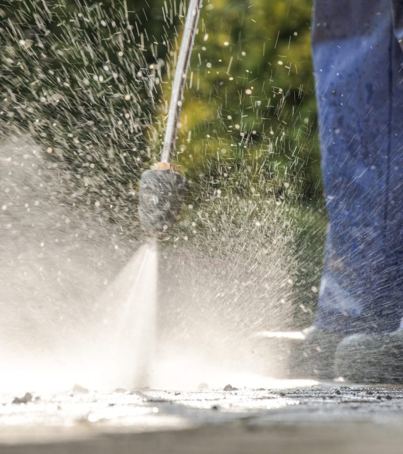 Pavement Power Cleaning. Pressure Washer in Action. Closeup Photo.